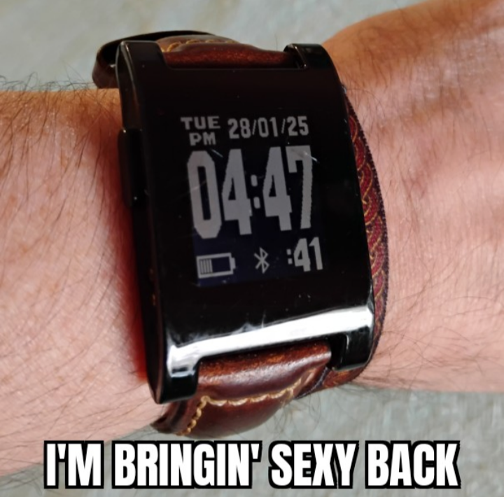 image of an original Pebble smartwatch on my wrist, the watch features a black frame and crisp eInk display